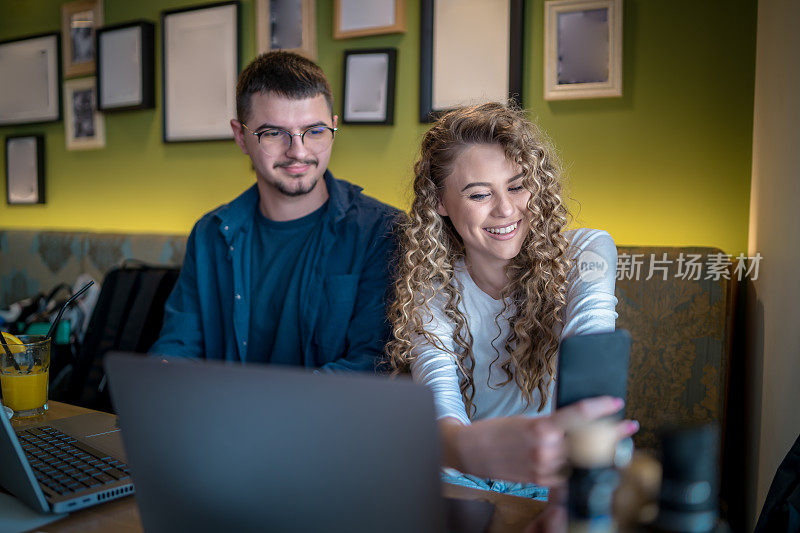 Business people working together at a café using their laptops